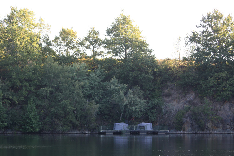 Looking out to the Steps Swim at Quarry Bank Fishery, France. It's a floating pontoon that's accessed by 31 steps down a near-vertical cliff.